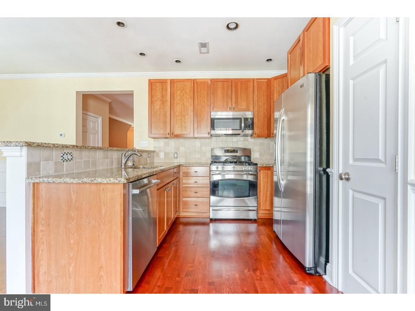 508 Captains Way Philadelphia, PA 19146 - Photo 7 of 25 a kitchen with stainless steel appliances a refrigerator and a sink
