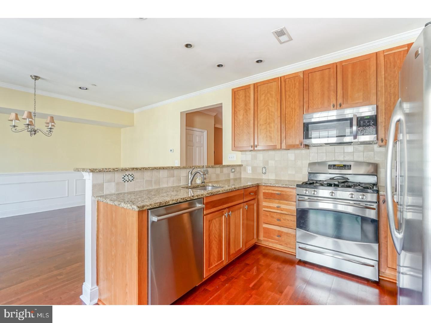 508 Captains Way Philadelphia, PA 19146 - Photo 9 of 25 a kitchen with stainless steel appliances granite countertop a stove a sink and a refrigerator