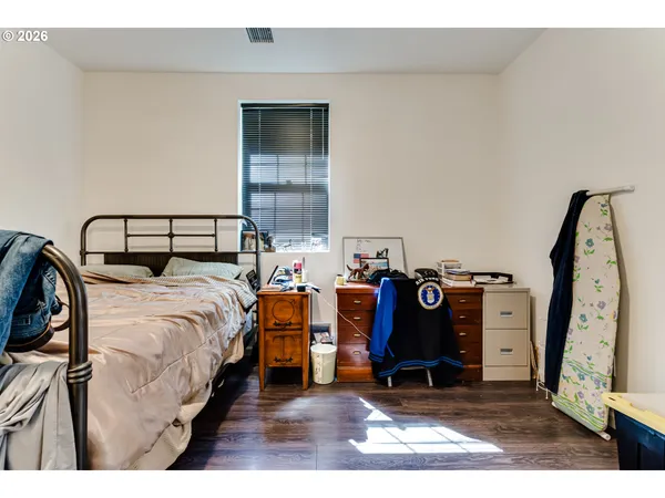 a bed room with a bed and a wooden floor