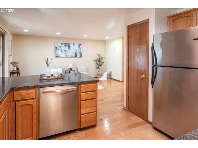 a kitchen with stainless steel appliances a refrigerator and a sink