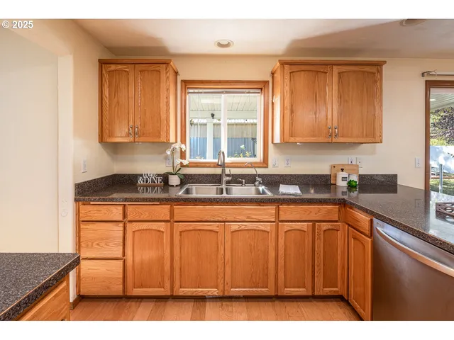 a kitchen with stainless steel appliances granite countertop a sink stove and cabinets