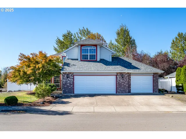a front view of a house with a garden