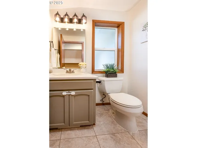 a bathroom with a sink a toilet and mirror
