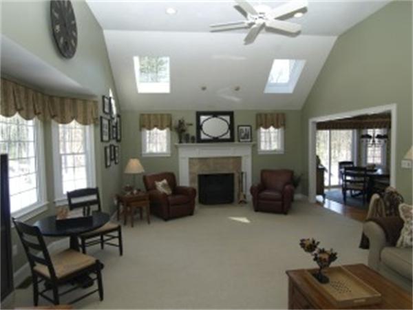 151 Green Road Bolton, MA 01740 - Photo 11 of 28 a living room with furniture and a fireplace