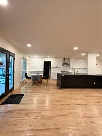 a view of kitchen with kitchen island microwave cabinets and refrigerator