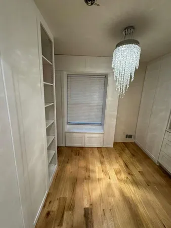 a view of an empty room and wooden floor