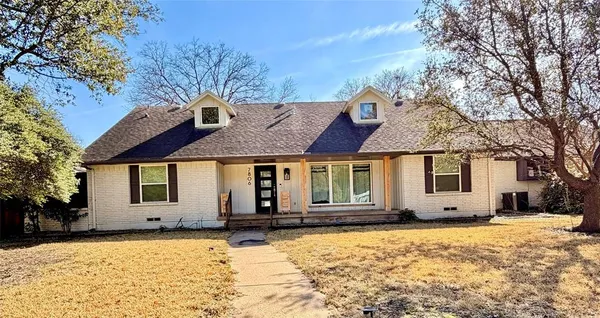 a front view of a house with a yard covered with snow