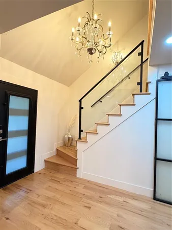 a view of entryway and hall with wooden floor