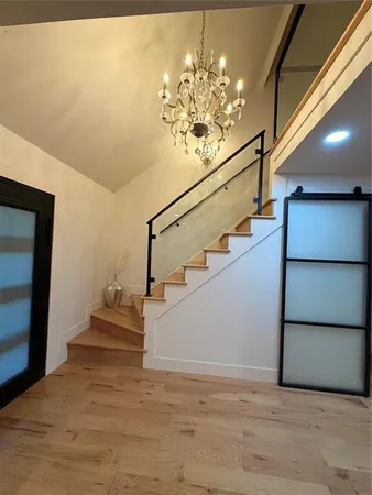 a view of entryway and hall with wooden floor