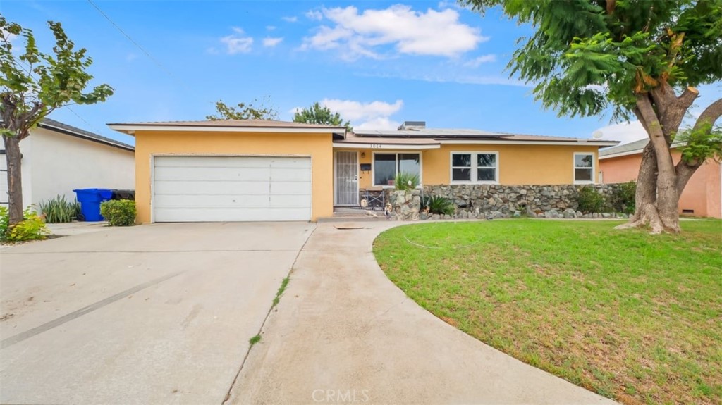 3064 West Atchison Street Rialto, CA 92376 - Photo 1 of 1 a view of a house with a yard and plants
