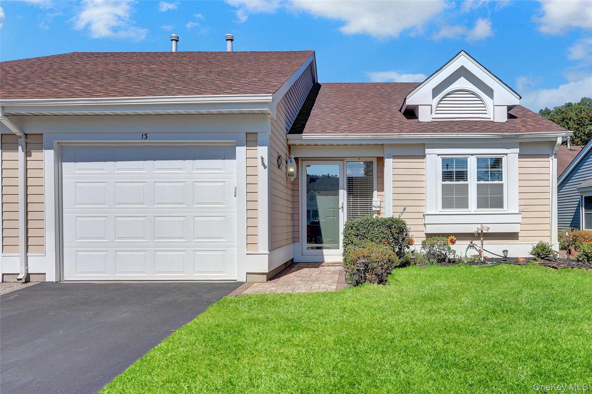 13 Oakdale Court Ridge, NY 11961 - Photo 1 of 1 View of front of property featuring roof with shingles, a front lawn, asphalt driveway, and an attached garage