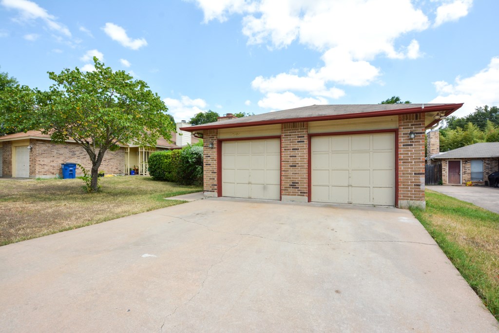 2104 Courtney Street, Unit B Austin, TX 78745 - Photo 1 of 1 a front view of a house with a yard and garage