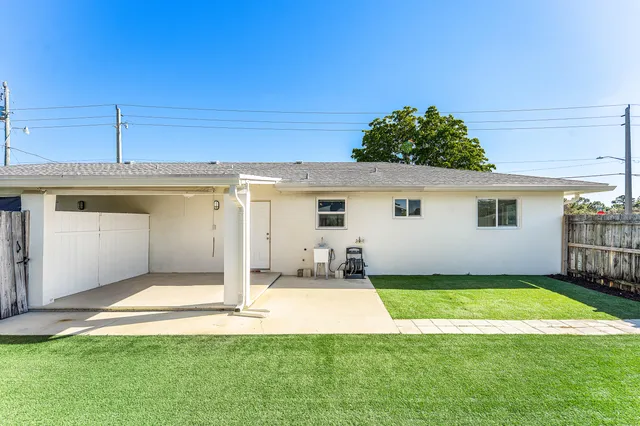 a view of a backyard with wooden fence