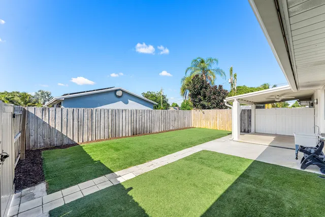 a view of a backyard with plants and a backyard