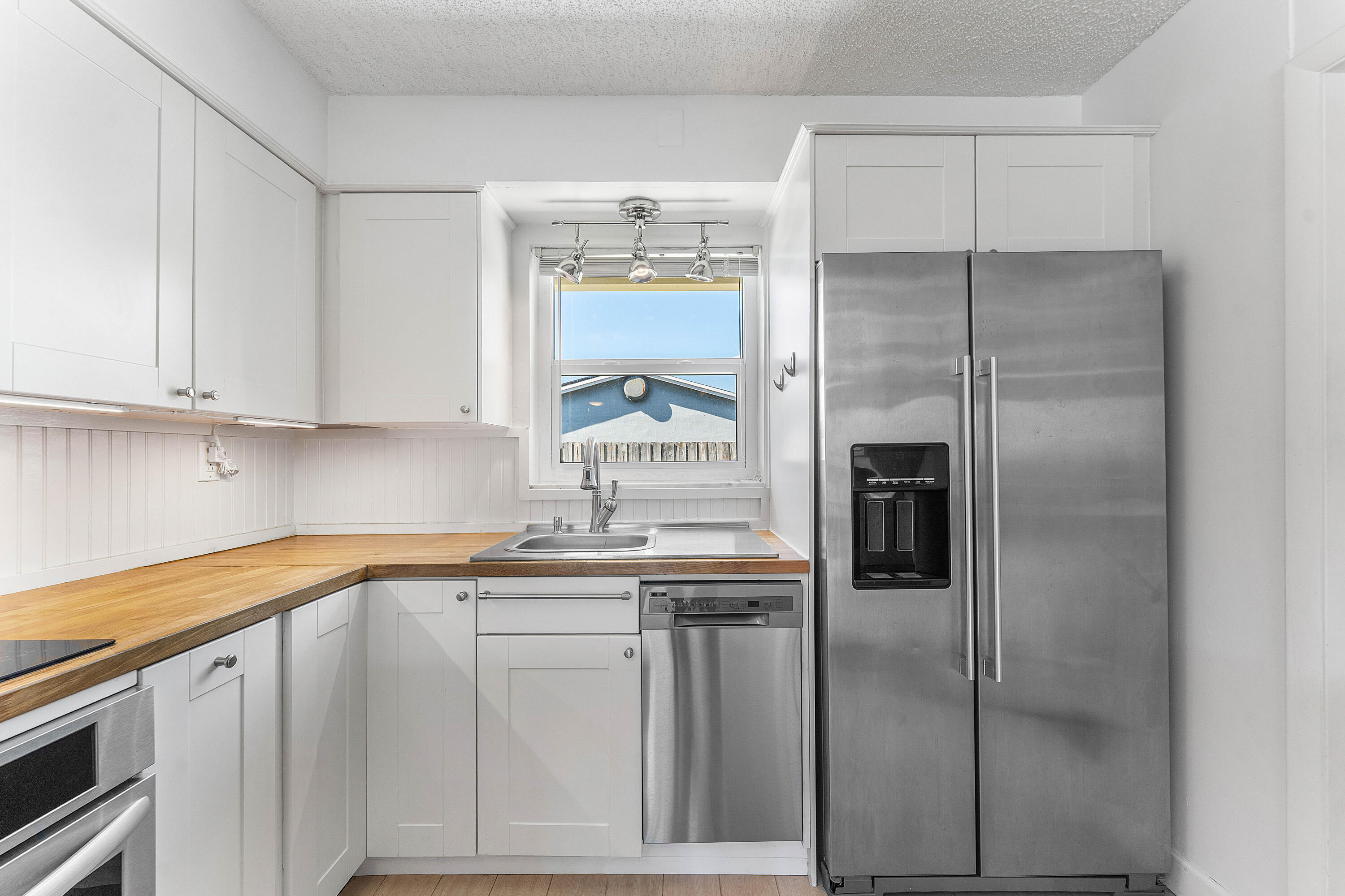 7643 Overlook Road Lake Worth, FL 33462 - Photo 4 of 29 a kitchen with stainless steel appliances granite countertop a refrigerator and a sink