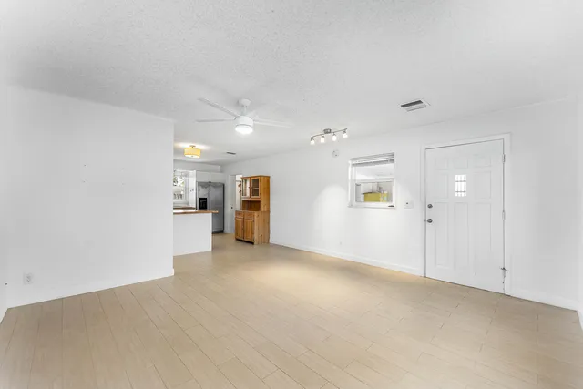 an empty room with windows and closet