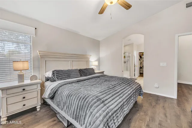 a bedroom with a bed and a chandelier