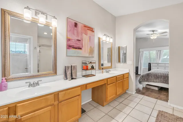 a spacious en suite bathroom with double sink and a mirror