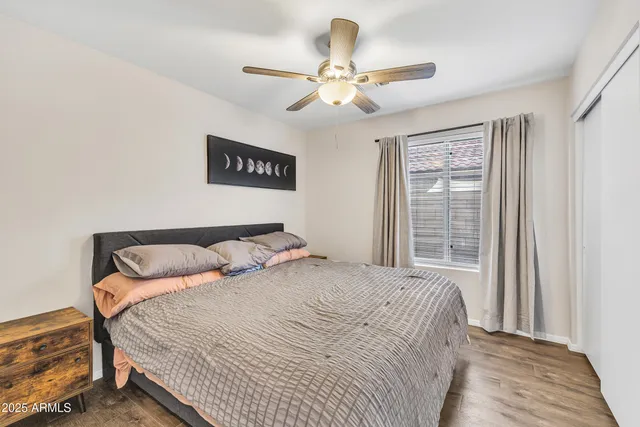 a bedroom with a large bed and a window