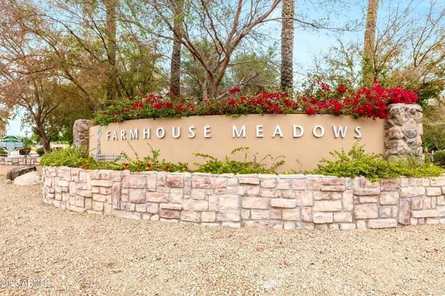 a street sign that is sitting on a brick wall