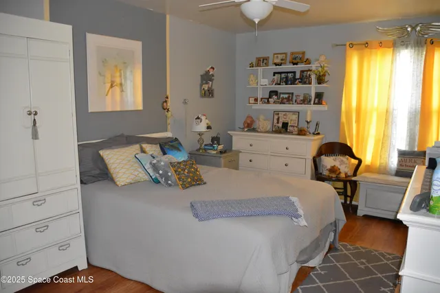 a large bed sitting in a bedroom next to a window