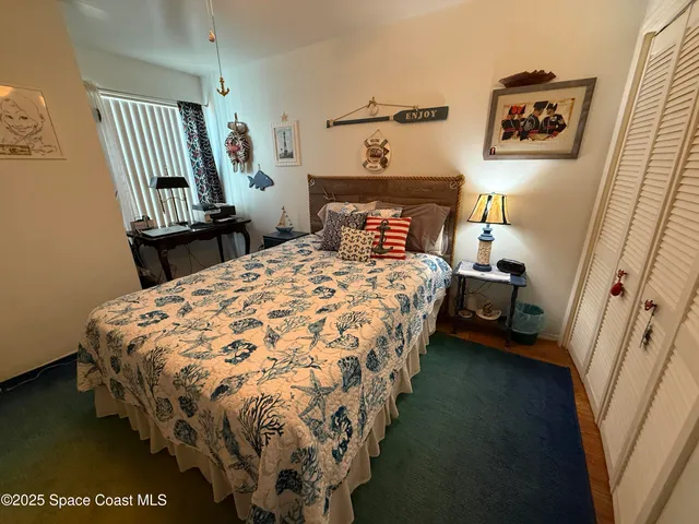 a bedroom with a bed and a dresser in it