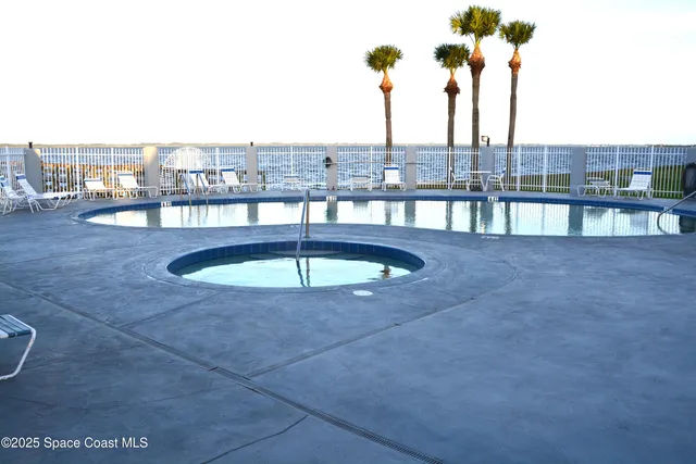 a view of a house with roof deck and sitting area
