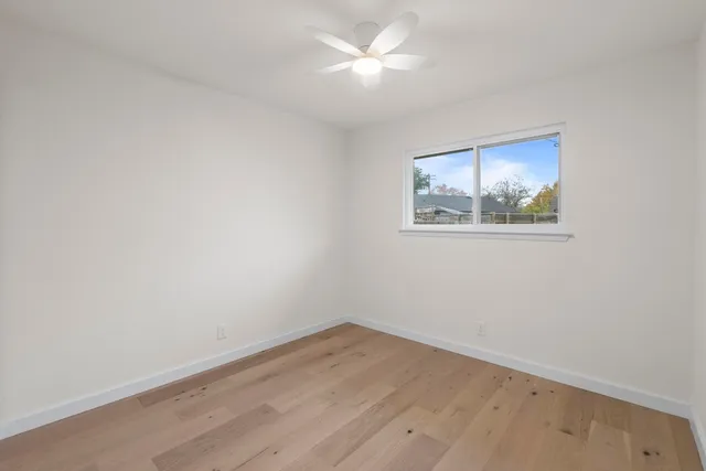 an empty room with a painting on the wall