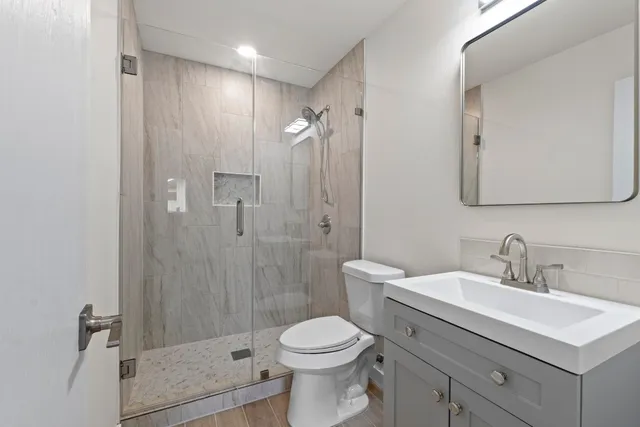 a bathroom with a sink toilet and shower
