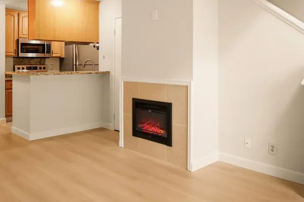 a view of a livingroom with a fireplace and television