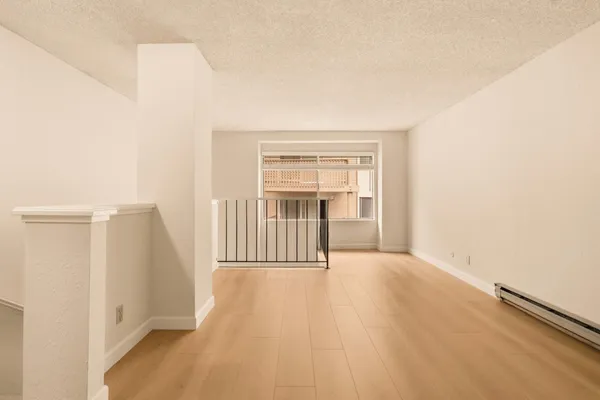 wooden floor in an empty room with a window