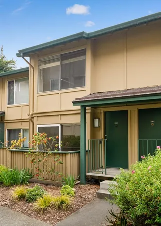 a view of a house with a window and plants