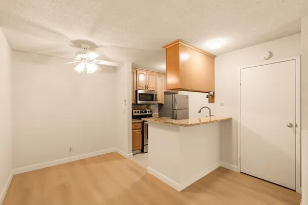a view of kitchen with cabinets and wooden floor