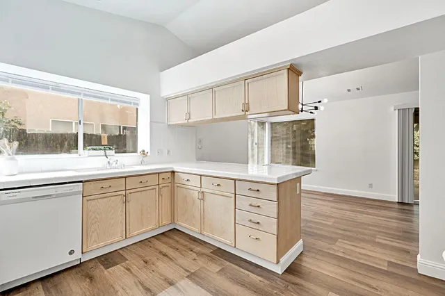 a kitchen with granite countertop white cabinets and a sink
