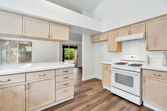 a kitchen with white cabinets and white appliances