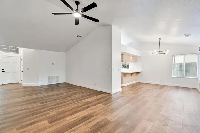 wooden floor in an empty room with a window