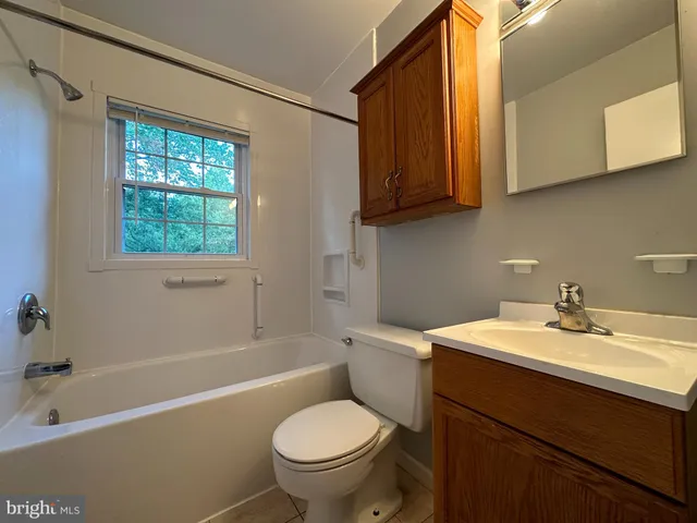 a bathroom with a sink a toilet and bathtub