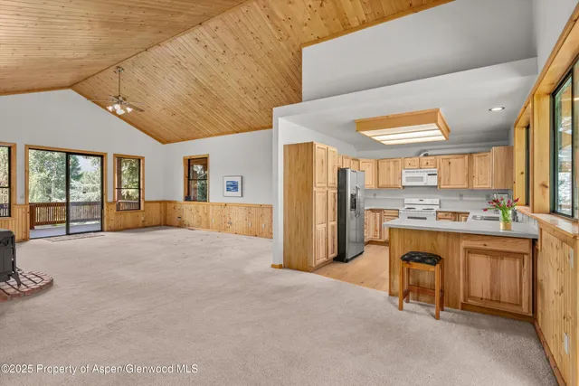 a large kitchen with a table and chairs
