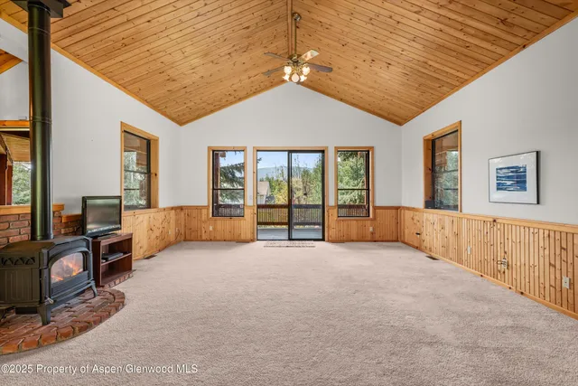 a spacious bedroom with a large bed and a large window