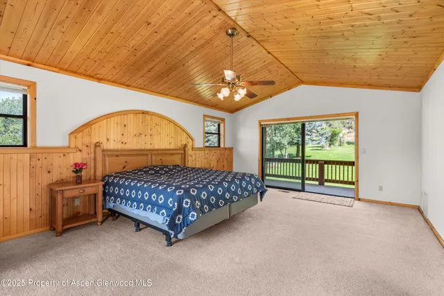 a bed room with a bed and a chandelier