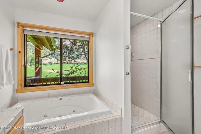 a bathroom with a bathtub and window