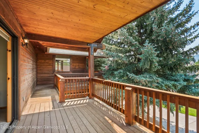 a view of a balcony with wooden floor