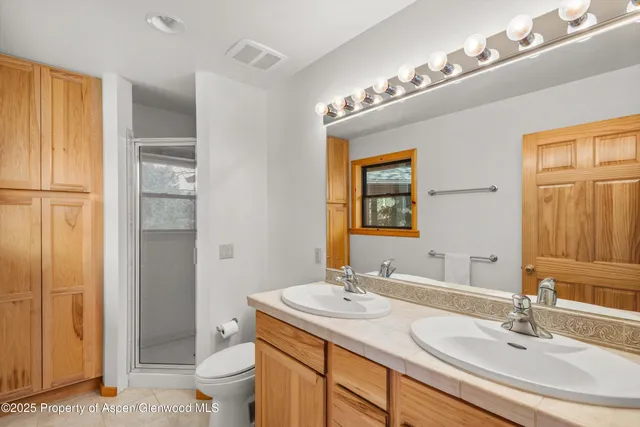 a bathroom with a sink double vanity and a toilet