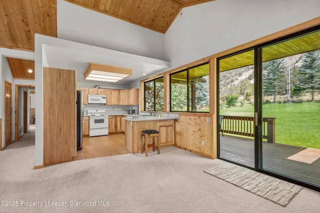 a view of living room with furniture and floor to ceiling window