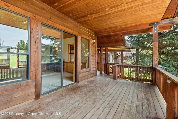 a view of a balcony with wooden floor