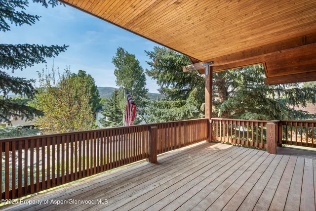 a balcony with wooden floor and outdoor space