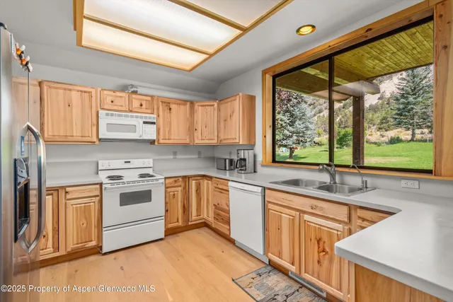 a kitchen with a sink stove and cabinets