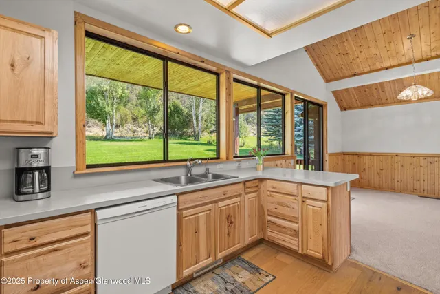 a kitchen with a sink and large window