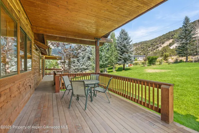 a view of a chairs and table on the wooden deck