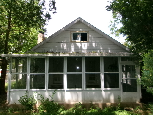 607 North Fleming Road Woodstock, IL 60098 - Photo 3 of 12 a front view of a house with a garden